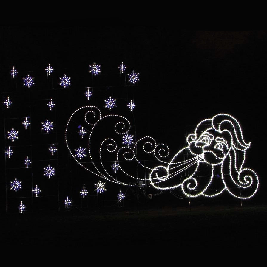A Christmas silhouette LED display featuring a whimsical Old Man Winter character blowing snowflakes. The display includes bright white LED lights forming the character's face and beard, with swirling snowflake patterns illuminated by white and purple LED lights against a dark background.