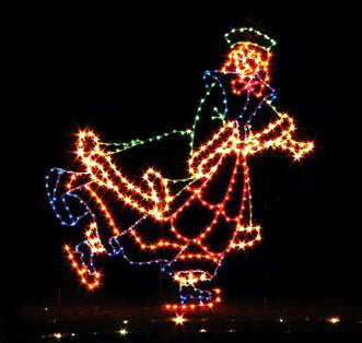 A colorful silhouette LED display of a woman ice skating in Victorian dress, illuminated against a dark background. The lights outline her figure with white, yellow, purple, blue, green and red LED lights, creating a festive holiday spirit.