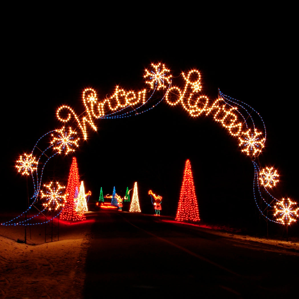 Winter Lights written in large script on an archway display featuring illuminated snowflakes, creating a festive and enchanting entrance for holiday events.
