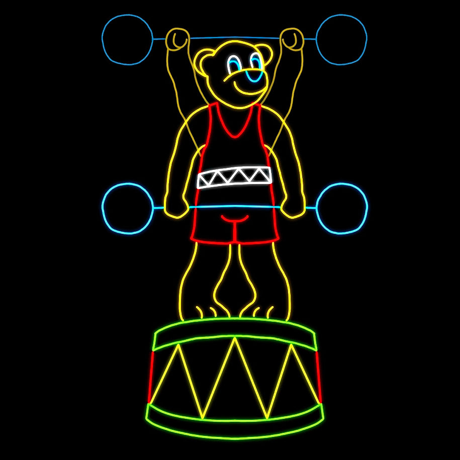 A vibrant LED silhouette display of a teddy bear lifting weights. The animated teddy bear is dressed in a red singlet and stands proudly on a drum. The display features bright colors, with the bear outlined in yellow, the weights in blue, and the drum in green and red. The scene is playful and engaging, making it an eye-catching decoration against a dark background.