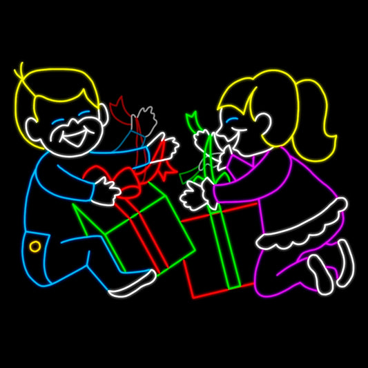 A vibrant animated LED silhouette display featuring two children joyfully unwrapping Christmas presents. The scene is outlined with bright colors, with the boy in blue and yellow LED lights and the girl in pink and pink LED lights, both holding red and green gift boxes with ribbons. The display captures the excitement and happiness of Christmas morning, set against a black background.