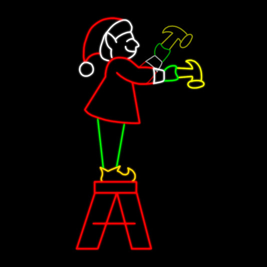 Christmas Elf with Hammer on Step Ladder Silhouette LED Display featuring an animated scene of a cheerful elf standing on a step ladder swinging a hammer. The display is illuminated with bright red, green, yellow, and white LED lights, creating a dynamic and festive scene against a black background.