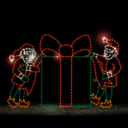 A silhouette LED display of two elves holding a ribbon on a large present, outlined with bright red, green, white, and orange LED lights, set against a dark background.