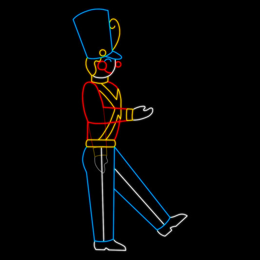 An animated silhouette LED display of a marching toy soldier in a colorful uniform with a tall blue hat. The soldier is outlined with bright red, yellow, blue, and white LED lights, with one leg raised and one arm extended, set against a black background.