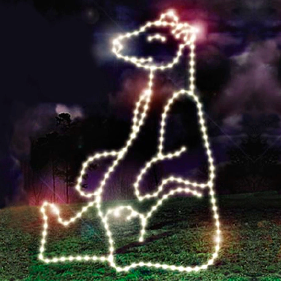 A glowing silhouette of a sitting polar bear, composed of bright white LED lights, illuminated against a dark, night sky background with faint green trees and clouds visible in the distance. This Christmas bear decoration is a perfect addition to any holiday event.