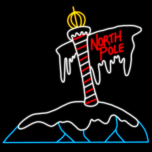A silhouette LED display of a North Pole sign with a red and white striped pole topped with a golden ornament. The sign reads "North Pole" in bright red letters, and the pole is surrounded by snow and icicles, outlined with vibrant white, red, yellow, and blue LED lights against a black background.