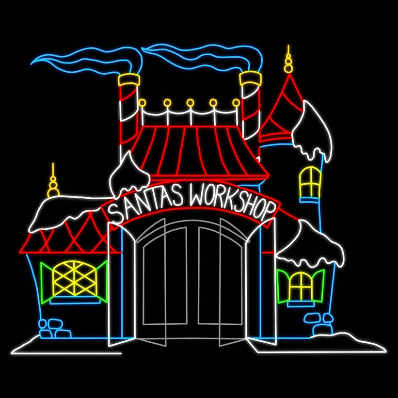 A vibrant LED silhouette display of "Santa's Workshop." The display features a festive building with a red roof, bright yellow windows, and snowy accents. The sign above the entrance reads "Santa's Workshop" in illuminated letters, while the chimneys billow with animated smoke. The colorful display captures the magical essence of Santa's headquarters, glowing brightly against a dark background.