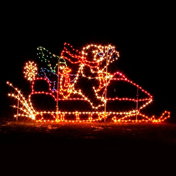 A vibrant LED display of a silhouette featuring a Christmas bear with a red scarf and a Christmas penguin with a green Santa hat riding a snowmobile. The outline is composed of green, yellow, blue, white and red LED lights, creating a festive and eye-catching decoration perfect for holiday events. The display is set against a dark background, enhancing the brightness and clarity of the lights.