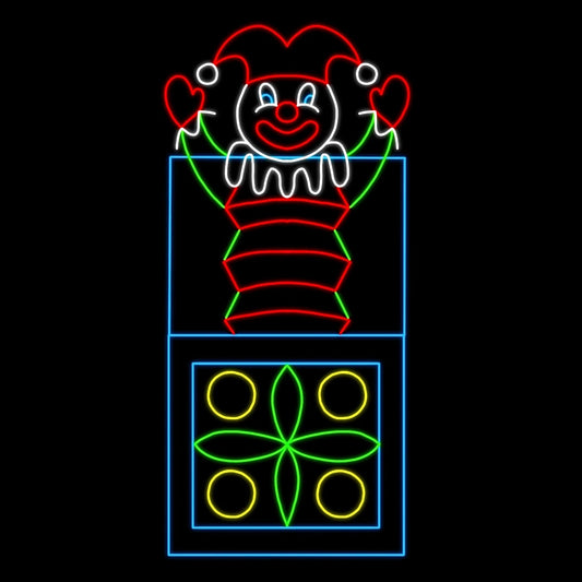 A vibrant animated LED silhouette display of a classic jack-in-the-box toy. The display features a cheerful clown popping out of a decorated box. The clown is dressed in a red and green outfit with a jester hat, smiling brightly with its arms raised. The box is adorned with colorful patterns, including yellow circles and green geometric shapes, all illuminated against a black background.