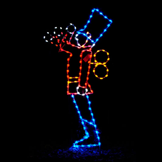 A silhouette LED display of a toy soldier saluting, outlined with bright red, blue, white, and yellow LED lights, set against a black background.